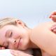 Acupuncture needles on the back of a beautiful woman - Portrait of a pretty lady in acupuncture therapy at the day spa